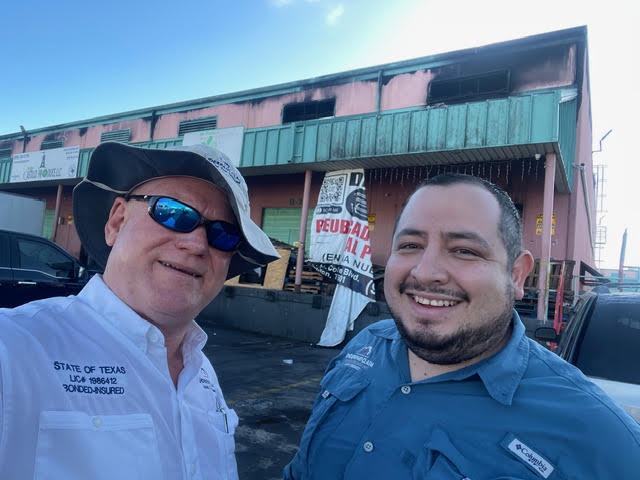 Cord Largo and an engineer at a fire-damaged commercial property