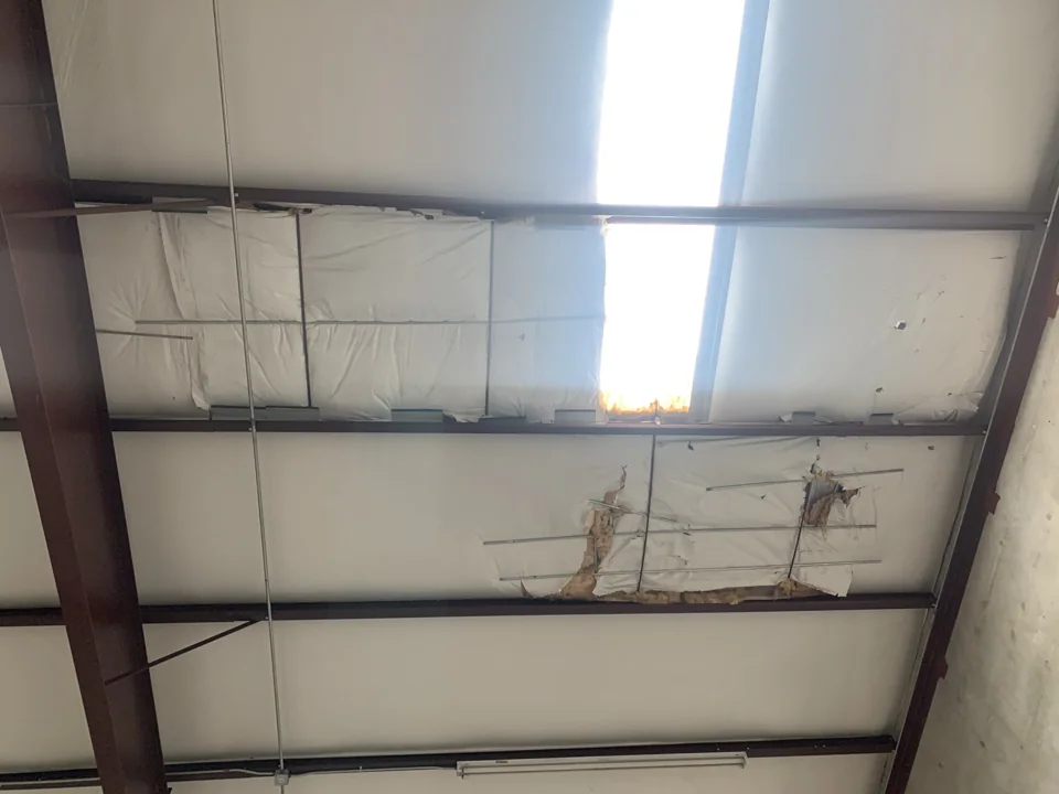 The interior view shows tears and openings in the insulation facing, with insulation exposed in several areas. Interior observations help identify locations that need closer examination above.