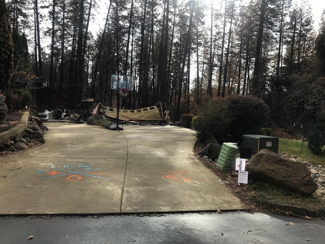 Driveway leading to the remains of a fire-damaged home