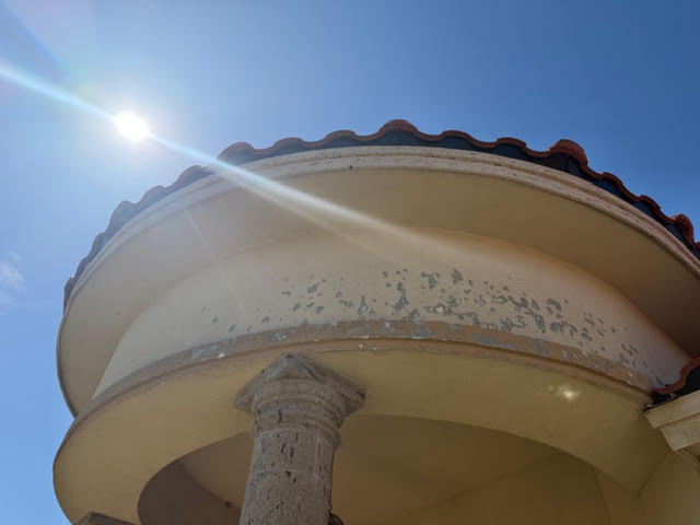 Marked exterior finish beneath the tile roof of a home